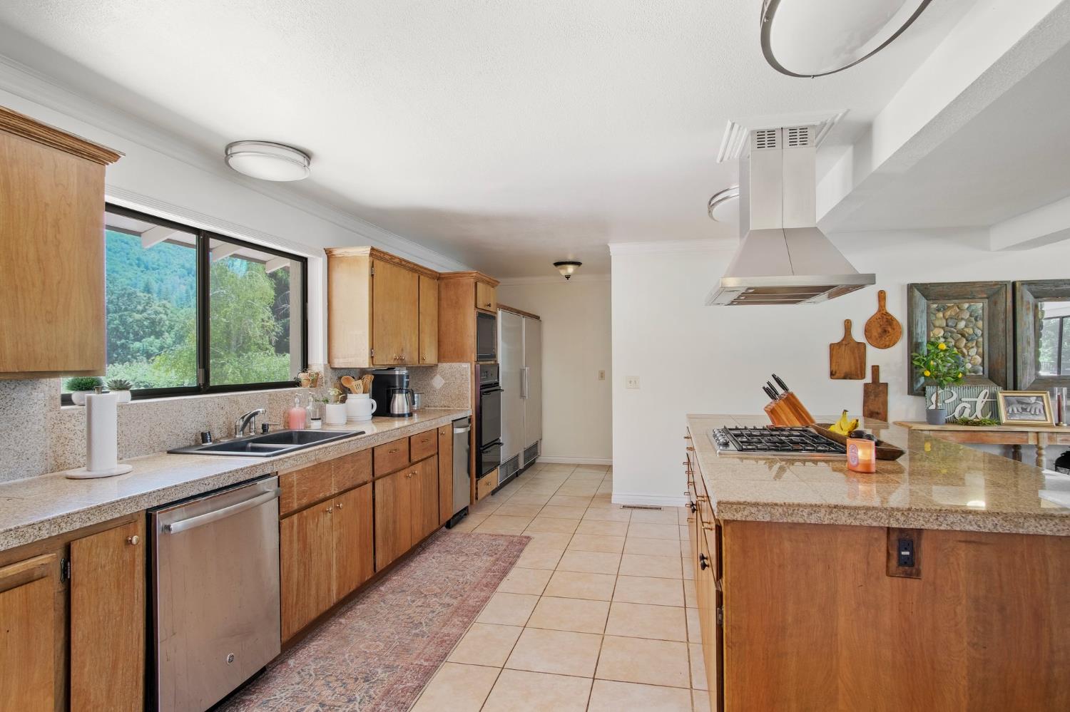 18950 Black Oak Road Sonora, CA 95370 - Photo 9 of 46 a kitchen with stainless steel appliances a sink stove and cabinets
