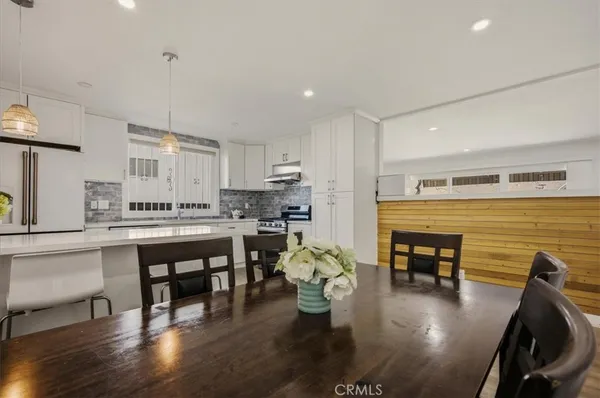 a kitchen with a table chairs stove and kitchen view