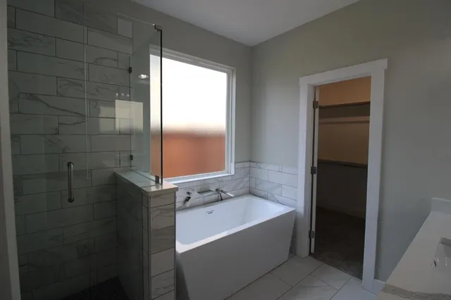 a bathroom with a bathtub and shower