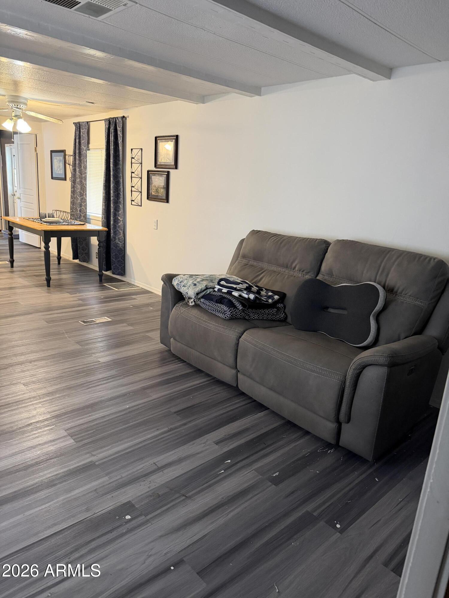 126 South Tomahawk Road, Unit 5 Apache Junction, AZ 85119 - Photo 11 of 14 a living room with furniture and wooden floor