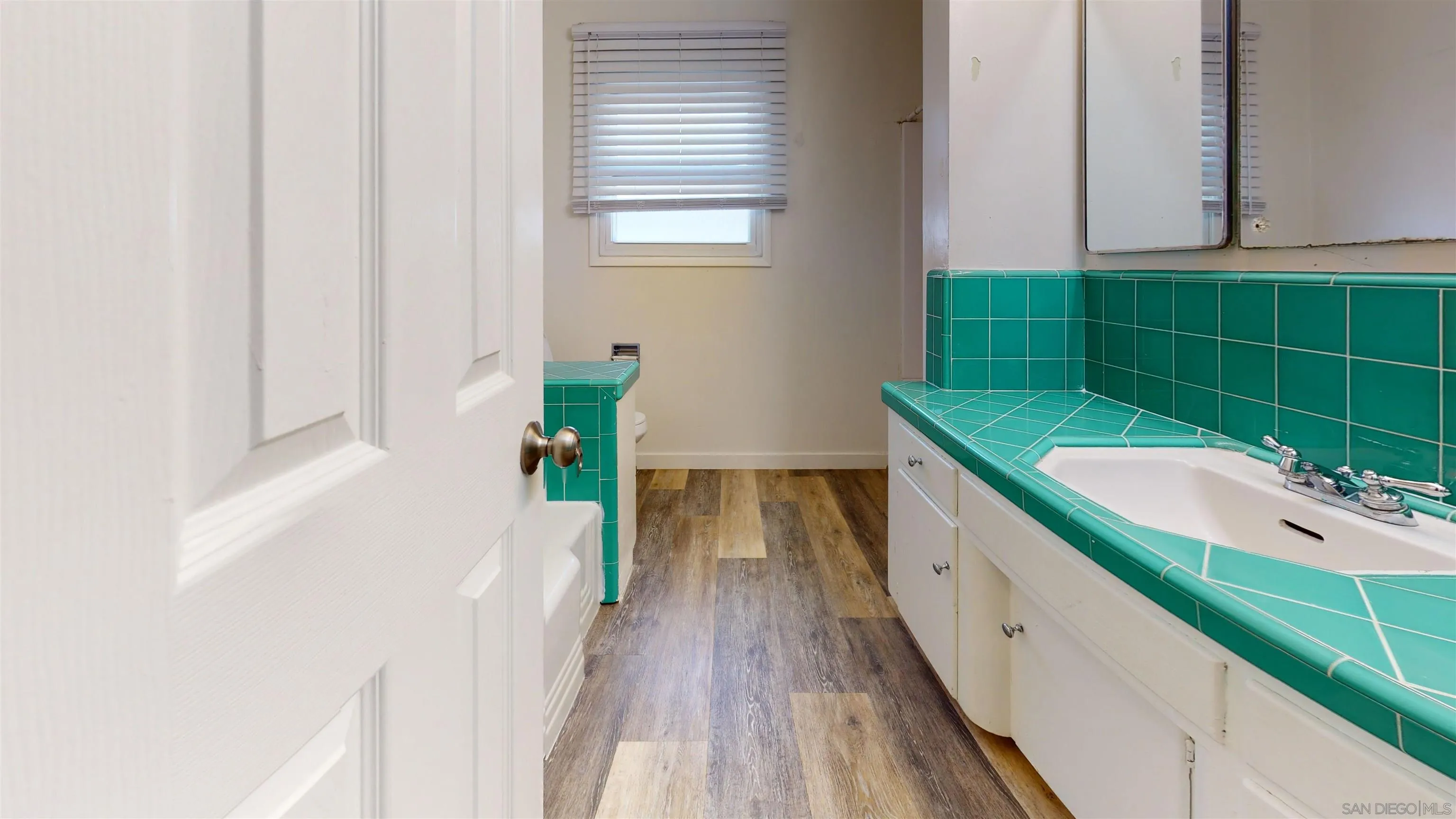 5555 Mary Ln Drive San Diego, CA 92115 - Photo 11 of 39 a view of a bathroom with a sink and a window