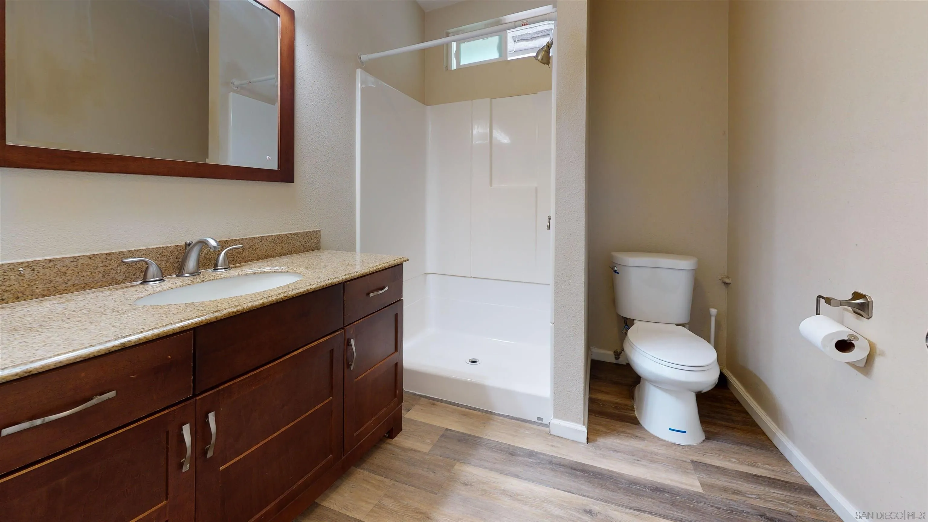 5555 Mary Ln Drive San Diego, CA 92115 - Photo 14 of 39 a bathroom with a sink a toilet and a mirror