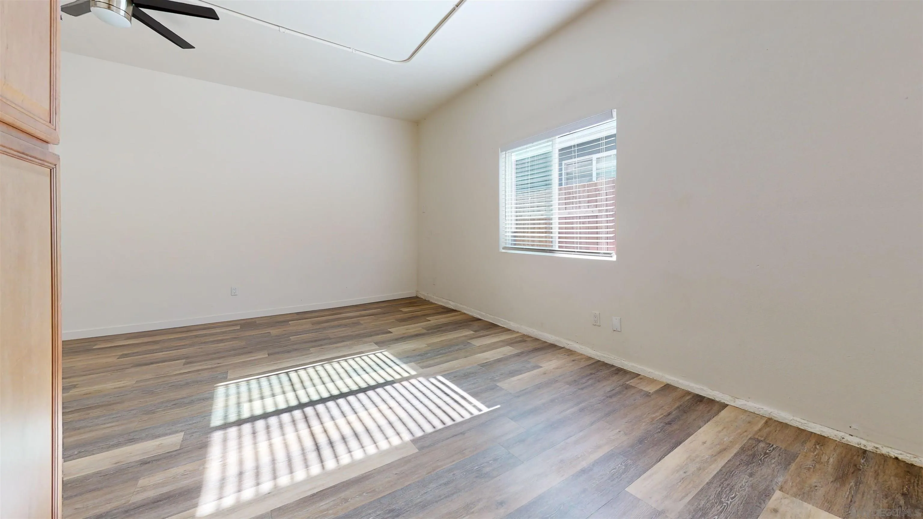 5555 Mary Ln Drive San Diego, CA 92115 - Photo 15 of 39 an empty room with wooden floor and windows