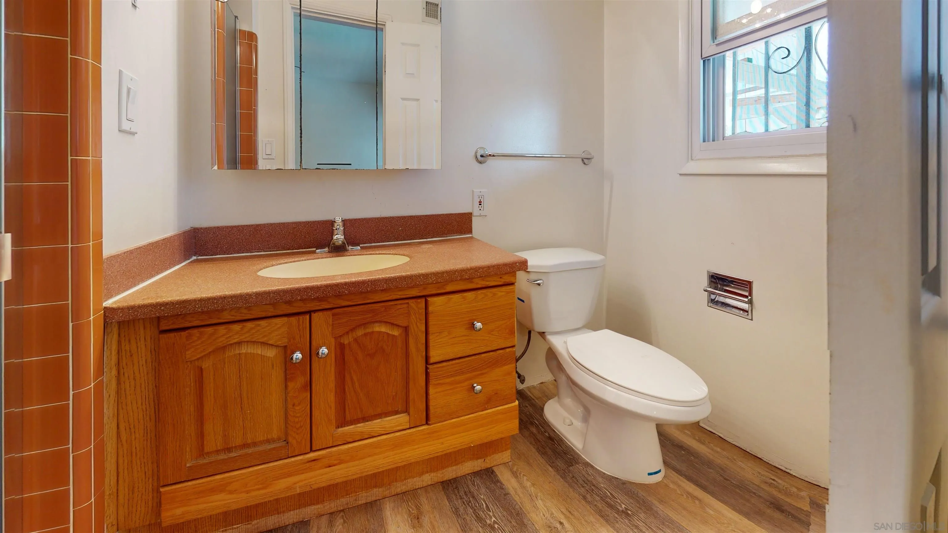 5555 Mary Ln Drive San Diego, CA 92115 - Photo 16 of 39 a bathroom with a sink a toilet and a mirror