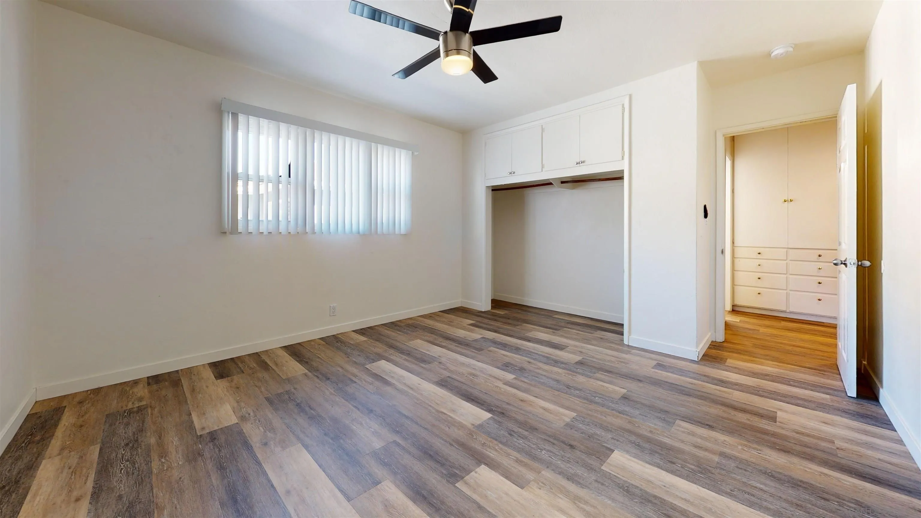 5555 Mary Ln Drive San Diego, CA 92115 - Photo 19 of 39 a view of empty room with wooden floor and window