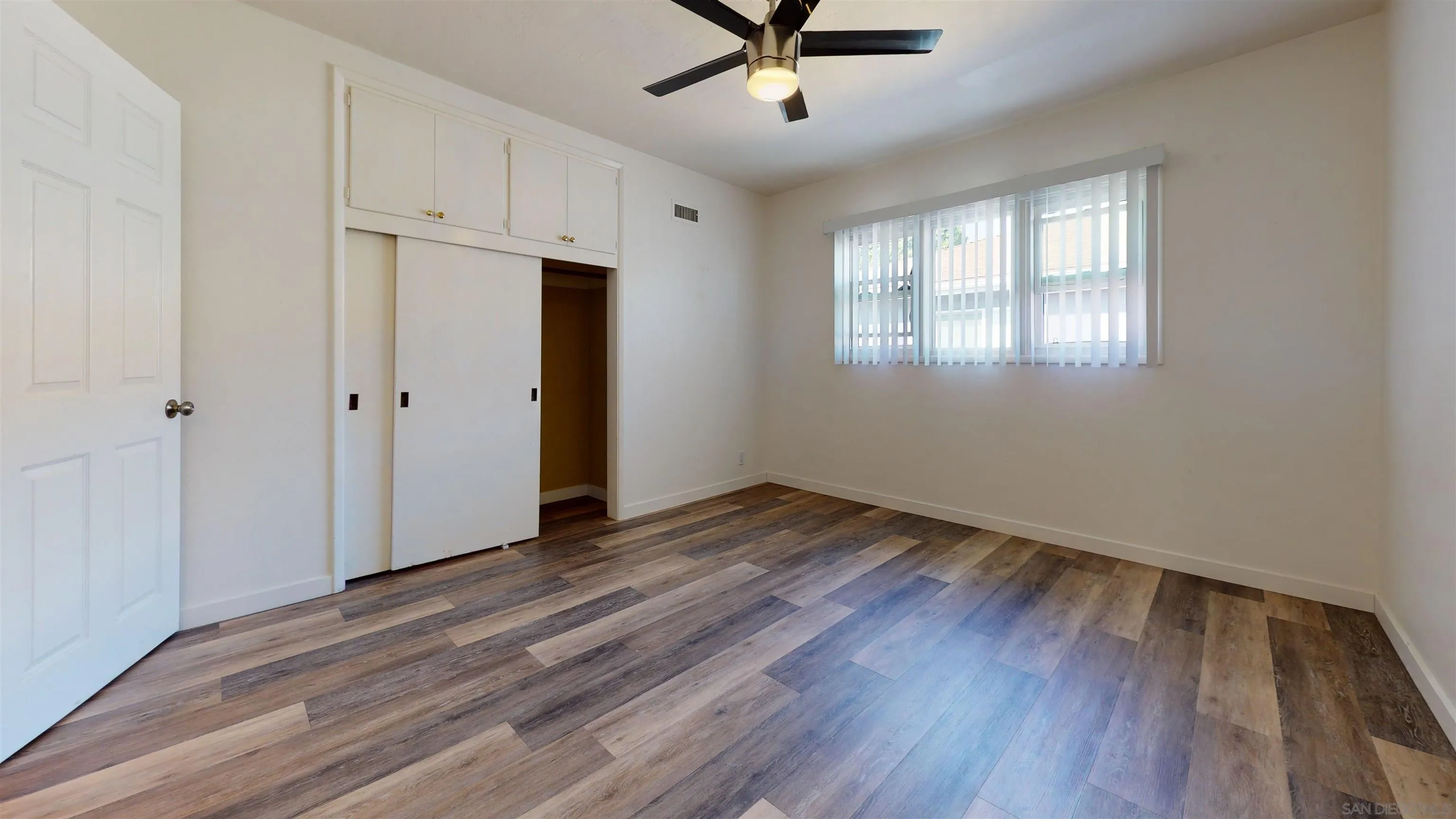 5555 Mary Ln Drive San Diego, CA 92115 - Photo 21 of 39 wooden floor in an empty room with a window