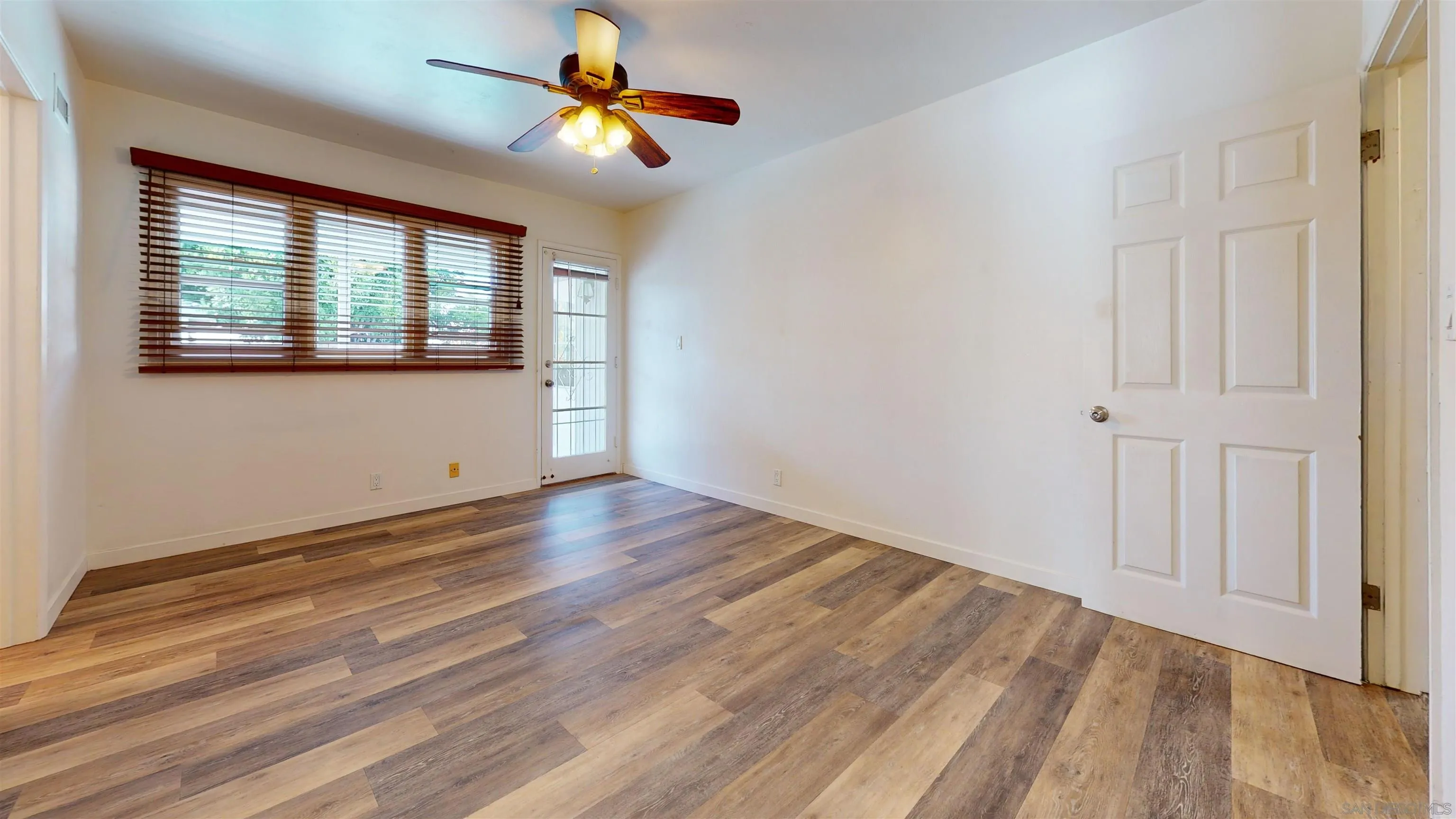 5555 Mary Ln Drive San Diego, CA 92115 - Photo 23 of 39 a view of empty room with wooden floor and fan