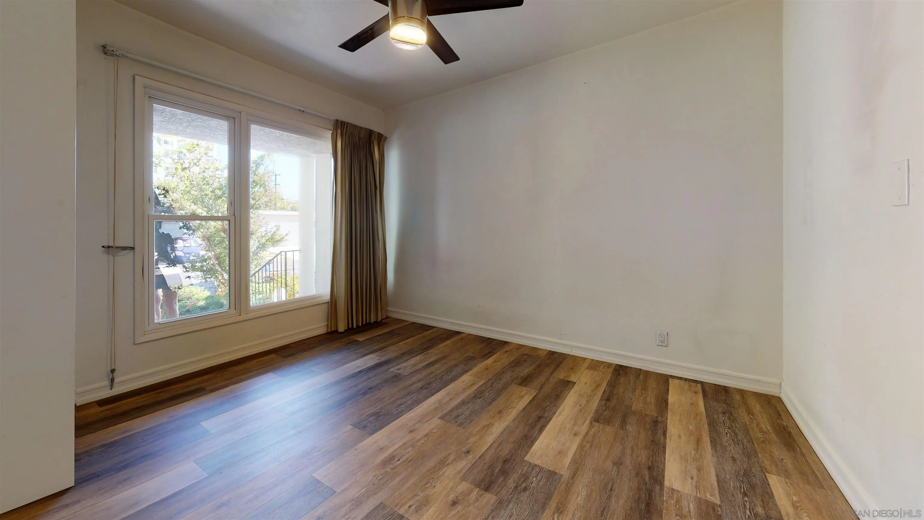 5555 Mary Ln Drive San Diego, CA 92115 - Photo 25 of 39 an empty room with wooden floor and windows