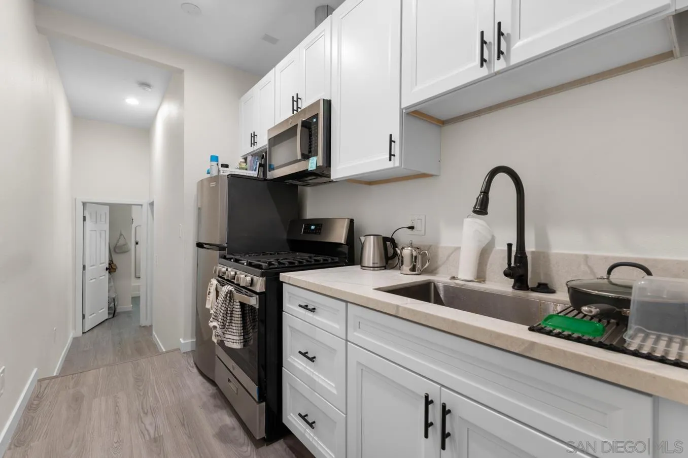 5555 Mary Ln Drive San Diego, CA 92115 - Photo 26 of 39 a kitchen with stainless steel appliances granite countertop a sink a stove and a refrigerator