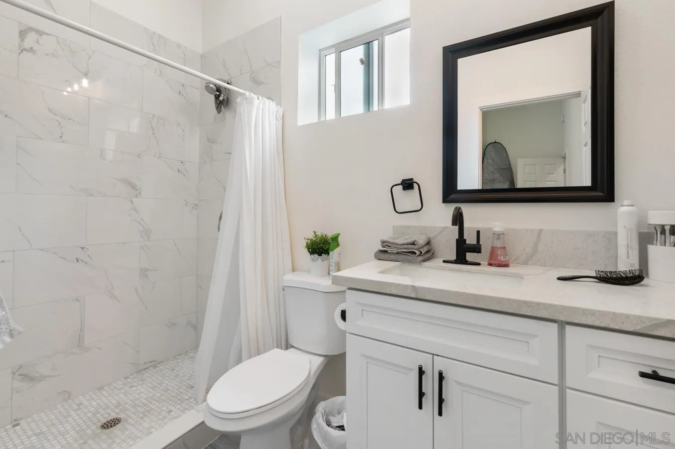 5555 Mary Ln Drive San Diego, CA 92115 - Photo 32 of 39 a bathroom with a granite countertop toilet sink and mirror