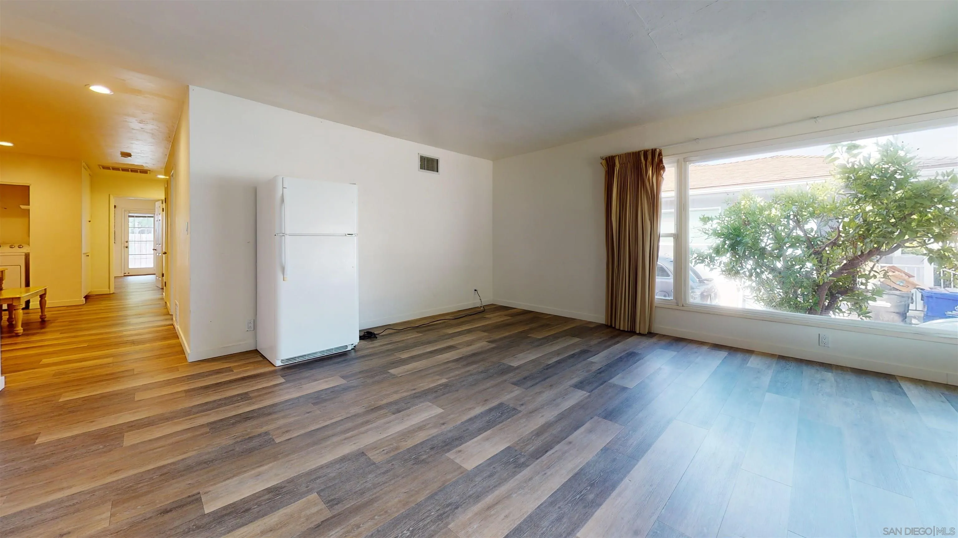 5555 Mary Ln Drive San Diego, CA 92115 - Photo 7 of 39 a view of a room with wooden floor and window