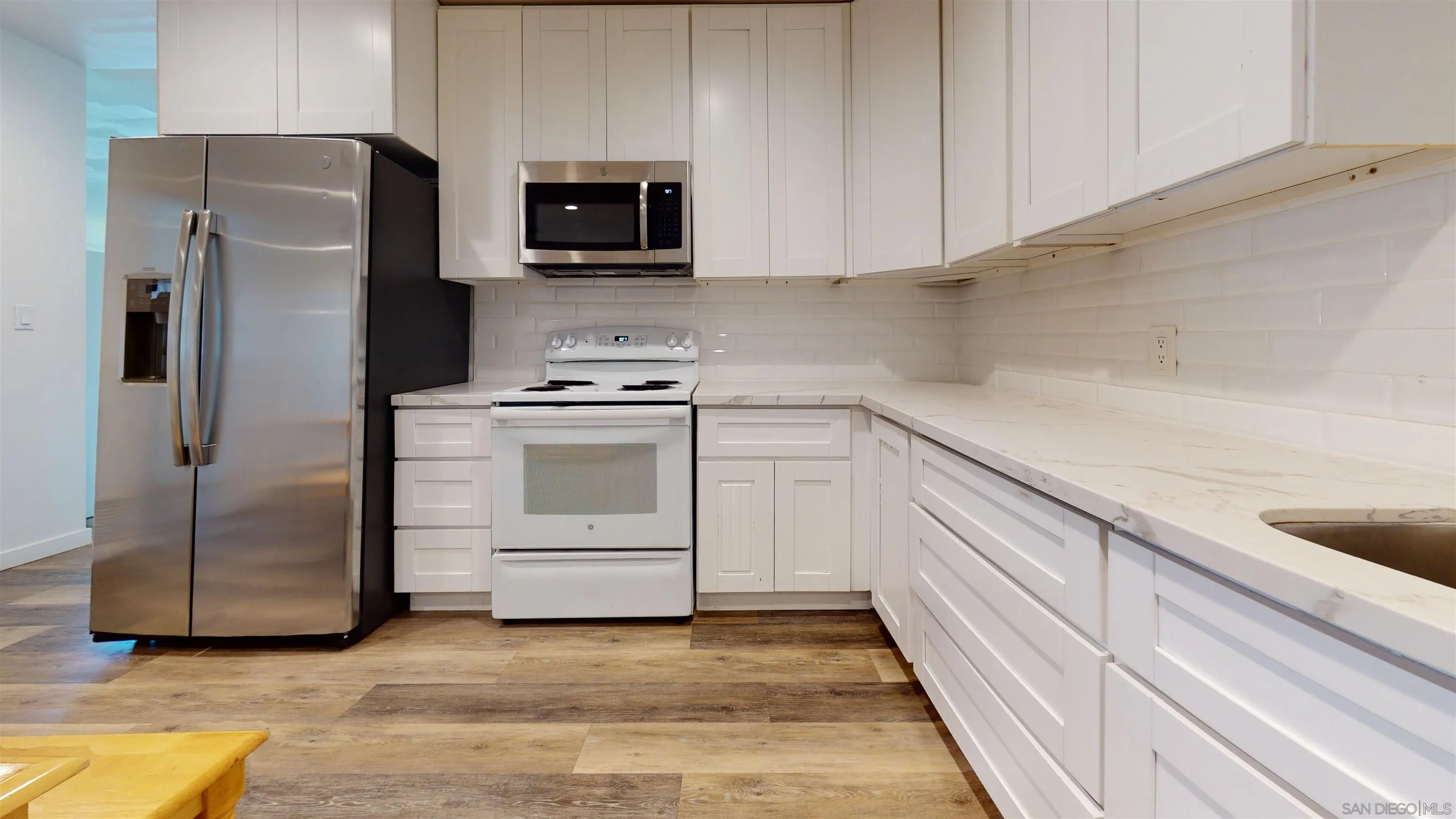5555 Mary Ln Drive San Diego, CA 92115 - Photo 10 of 39 a kitchen with a refrigerator stove and sink