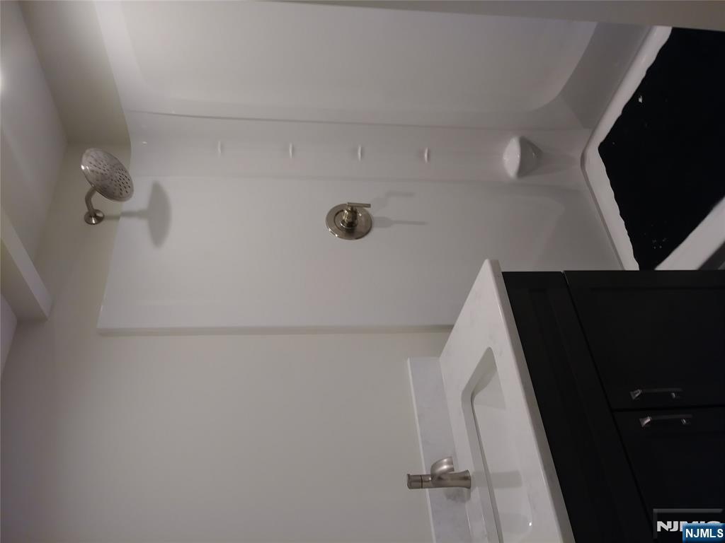 20 Goffle Road Midland Park, NJ 07432 - Photo 12 of 16 a bathroom with a sink a light fixture and a vanity