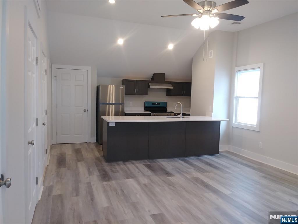 20 Goffle Road Midland Park, NJ 07432 - Photo 4 of 16 a kitchen with kitchen island sink refrigerator and window