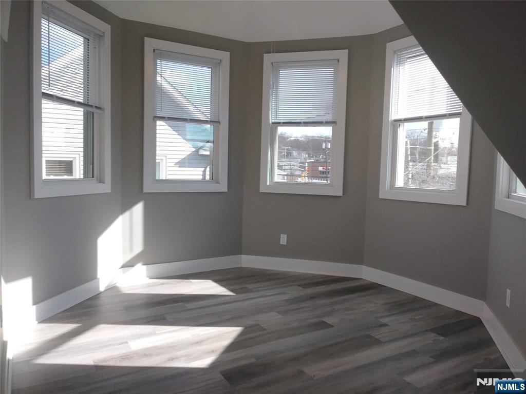 20 Goffle Road Midland Park, NJ 07432 - Photo 7 of 16 an empty room with wooden floor and windows