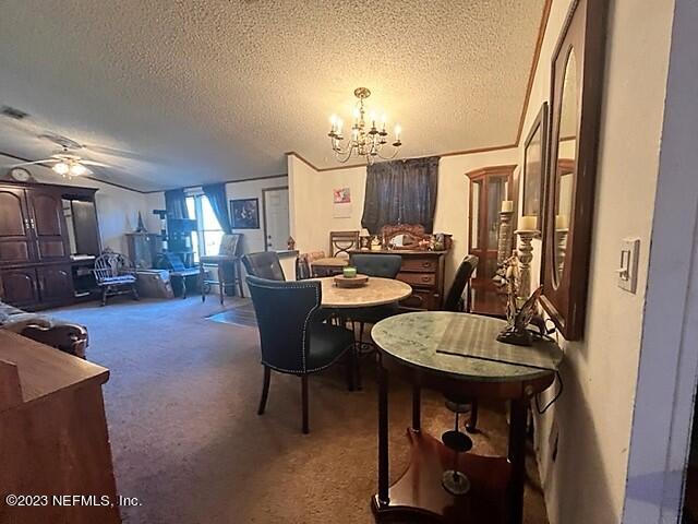380 East End Road San Mateo, FL 32187 - Photo 3 of 9 a living room with furniture a fireplace and a chandelier