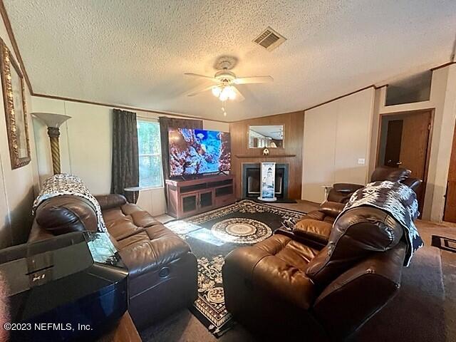 380 East End Road San Mateo, FL 32187 - Photo 4 of 9 a living room with furniture a ceiling fan and a rug