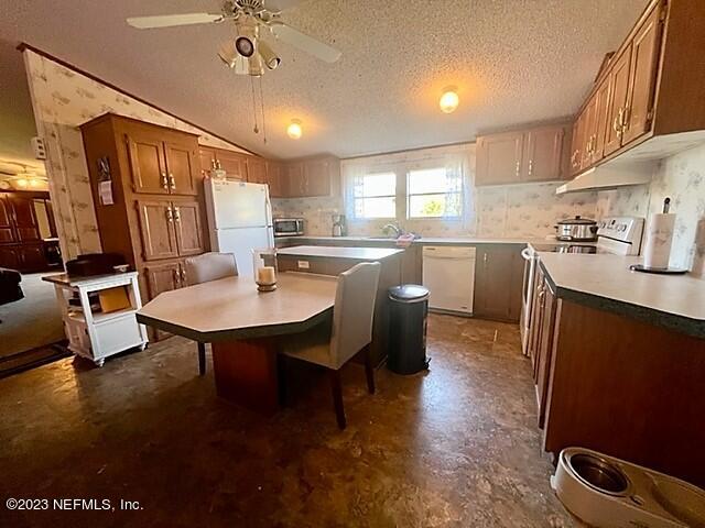 380 East End Road San Mateo, FL 32187 - Photo 5 of 9 a kitchen with a table chairs stove and refrigerator
