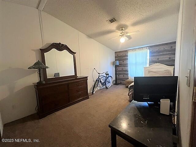 380 East End Road San Mateo, FL 32187 - Photo 6 of 9 a room with furniture and a flat screen tv