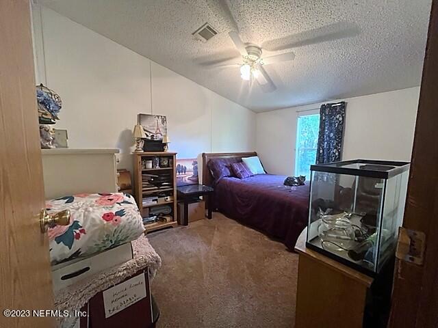 380 East End Road San Mateo, FL 32187 - Photo 8 of 9 a bedroom with bed and furniture