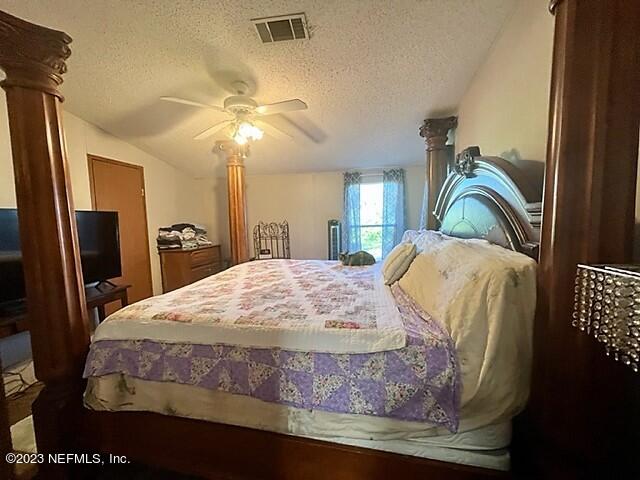 380 East End Road San Mateo, FL 32187 - Photo 9 of 9 a bedroom with a bed and a chandelier