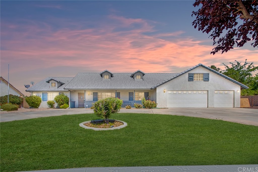 20434 Ochoa Road Apple Valley, CA 92307 - Photo 1 of 1 a front view of a house with a yard and garage