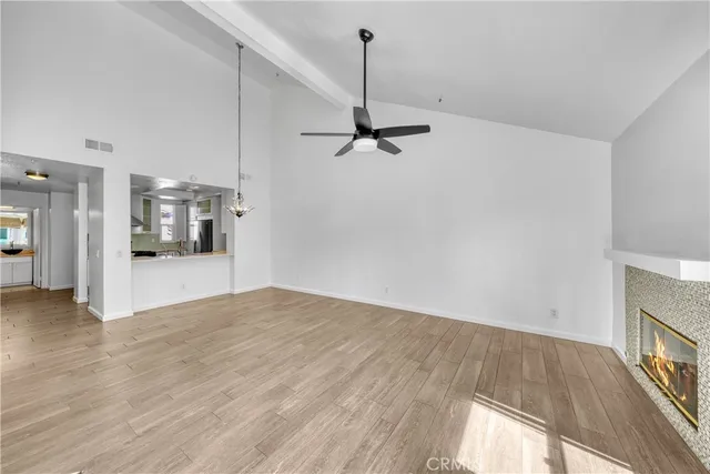 a view of an empty room with window and bathroom