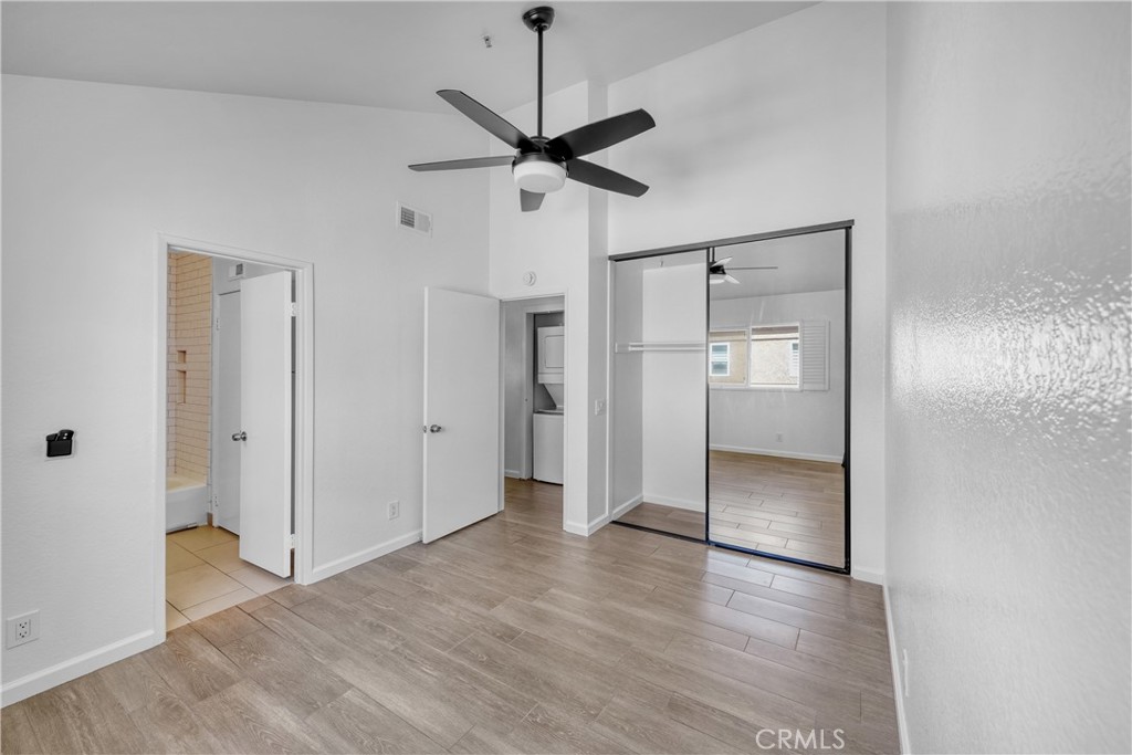2000 Pacific Coast Highway, Unit 309 Huntington Beach, CA 92648 - Photo 26 of 32 a view of a room with wooden floor and ceiling fan