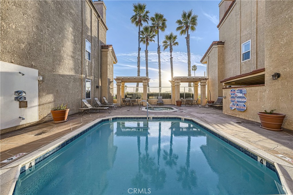 2000 Pacific Coast Highway, Unit 309 Huntington Beach, CA 92648 - Photo 30 of 32 a view of a swimming pool with a patio