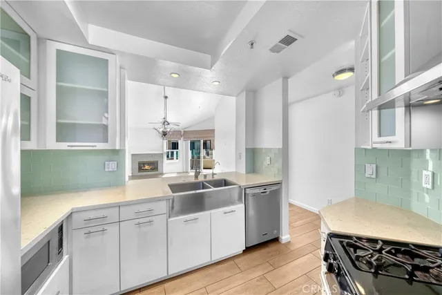 a kitchen with kitchen island a sink stove and refrigerator