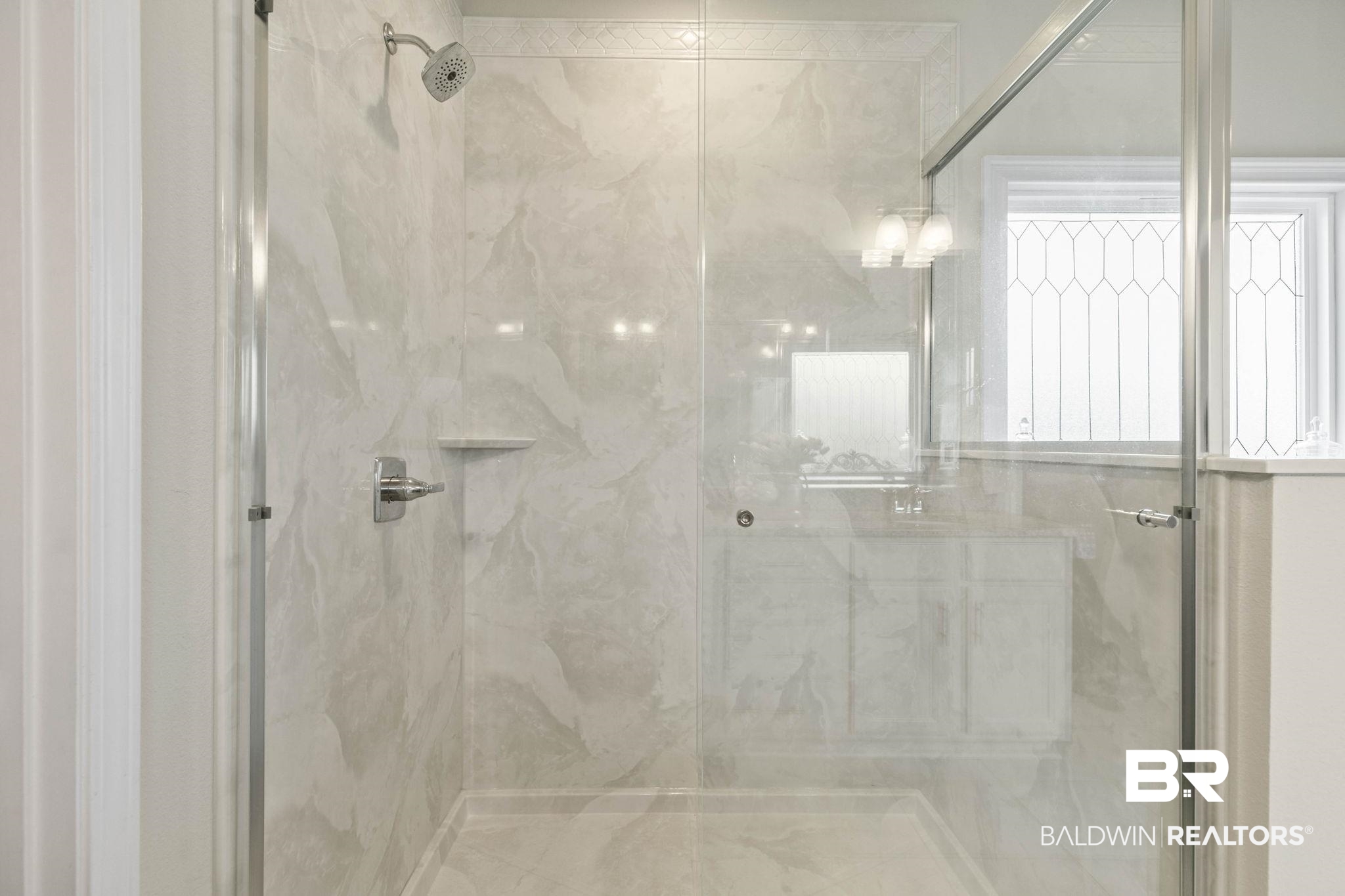 31187 Spoonbill Road Daphne, AL 36527 - Photo 28 of 85 Shower enclosure with glass paneling, full-height tile surround, rain shower head, built-in soap dish, and chrome fixtures