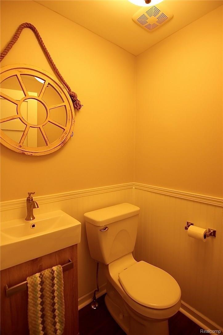 931 West 3rd Street Rochester, MI 48307 - Photo 14 of 62 Half bath with wood flooring and bead board trim.