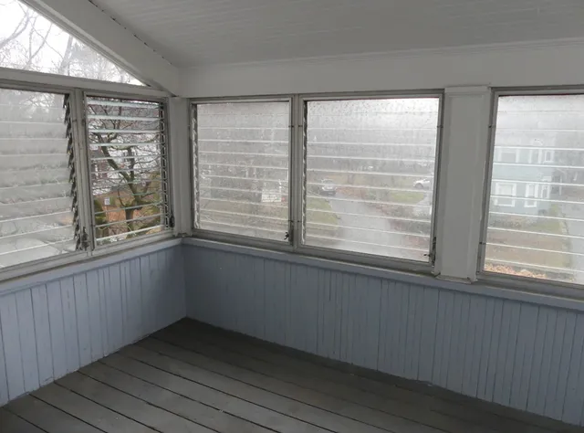 a view of an empty room with a window
