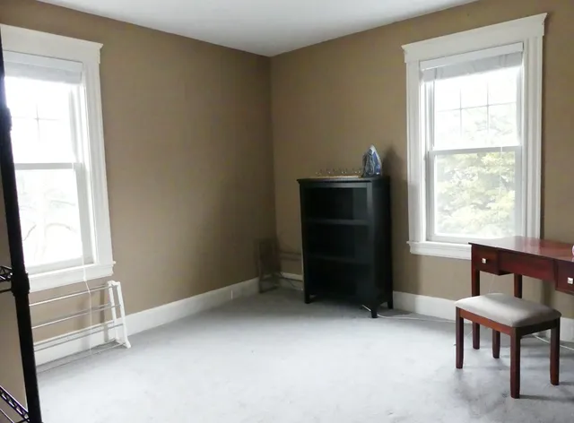 a room that has a dresser and a chair in it