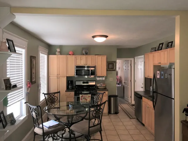 a kitchen with stainless steel appliances a refrigerator and a stove top oven