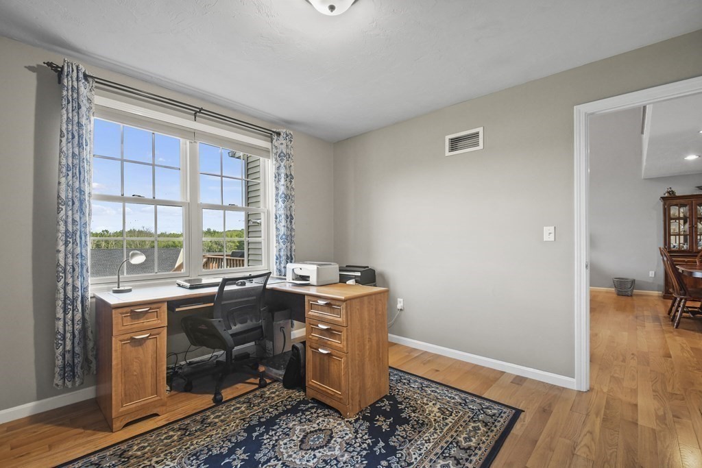 148 Ariel Circle, Unit 148 Sutton, MA 01590 - Photo 13 of 35 a room with a stove and wooden floor