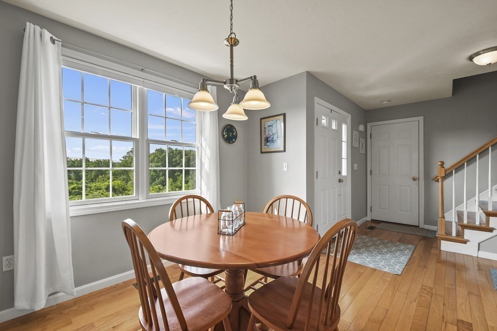148 Ariel Circle, Unit 148 Sutton, MA 01590 - Photo 18 of 35 a view of a dining room with furniture window and wooden floor
