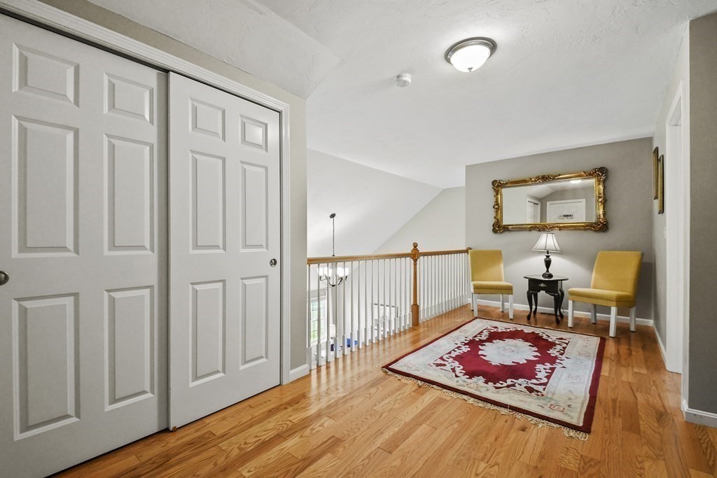 148 Ariel Circle, Unit 148 Sutton, MA 01590 - Photo 20 of 35 a living room with furniture rug and wooden floor