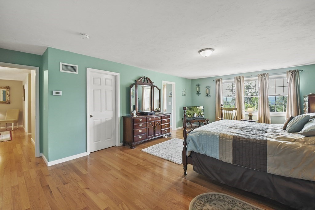 148 Ariel Circle, Unit 148 Sutton, MA 01590 - Photo 23 of 35 a living room with a bed furniture and a large window