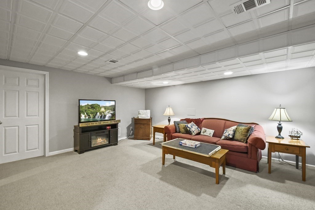 148 Ariel Circle, Unit 148 Sutton, MA 01590 - Photo 30 of 35 a living room with furniture and a flat screen tv