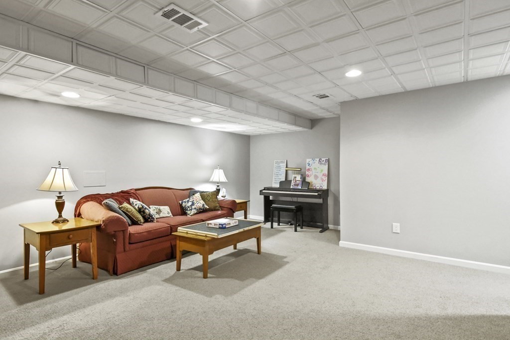 148 Ariel Circle, Unit 148 Sutton, MA 01590 - Photo 31 of 35 a living room with furniture and a piano