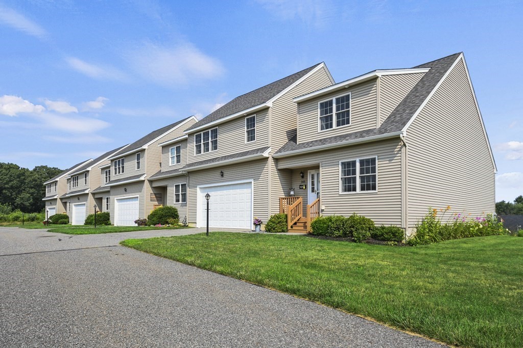 148 Ariel Circle, Unit 148 Sutton, MA 01590 - Photo 32 of 35 a front view of a house with garden and two windows