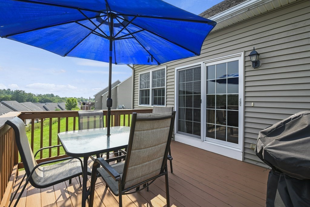 148 Ariel Circle, Unit 148 Sutton, MA 01590 - Photo 35 of 35 a view of a chair and table in the balcony
