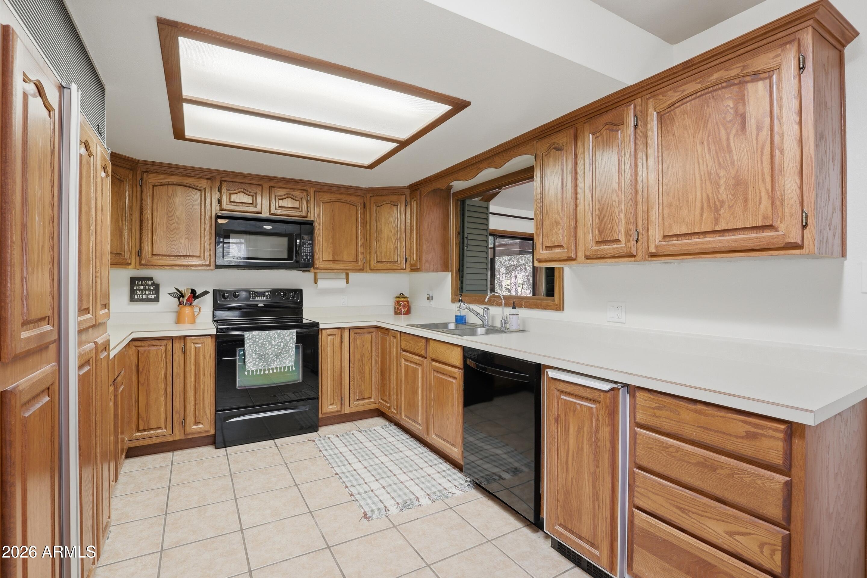 6740 Ridge Road Pine, AZ 85544 - Photo 11 of 35 a kitchen with kitchen island granite countertop a stove sink and cabinets