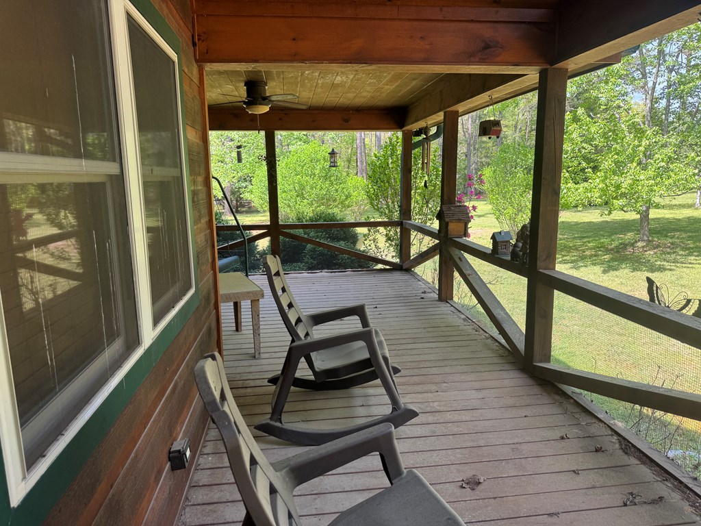 33 Big Tree Road Suches, GA 30572 - Photo 6 of 25 a view of a balcony with chairs and wooden floor