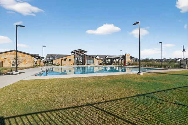 a swimming pool with yard and outdoor seating
