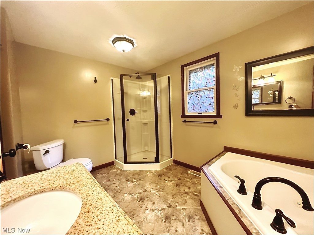 3122 Bedrock Road Northwest Dellroy, OH 44620 - Photo 17 of 23 Full bathroom with vanity, independent shower and bath, toilet, and tile floors