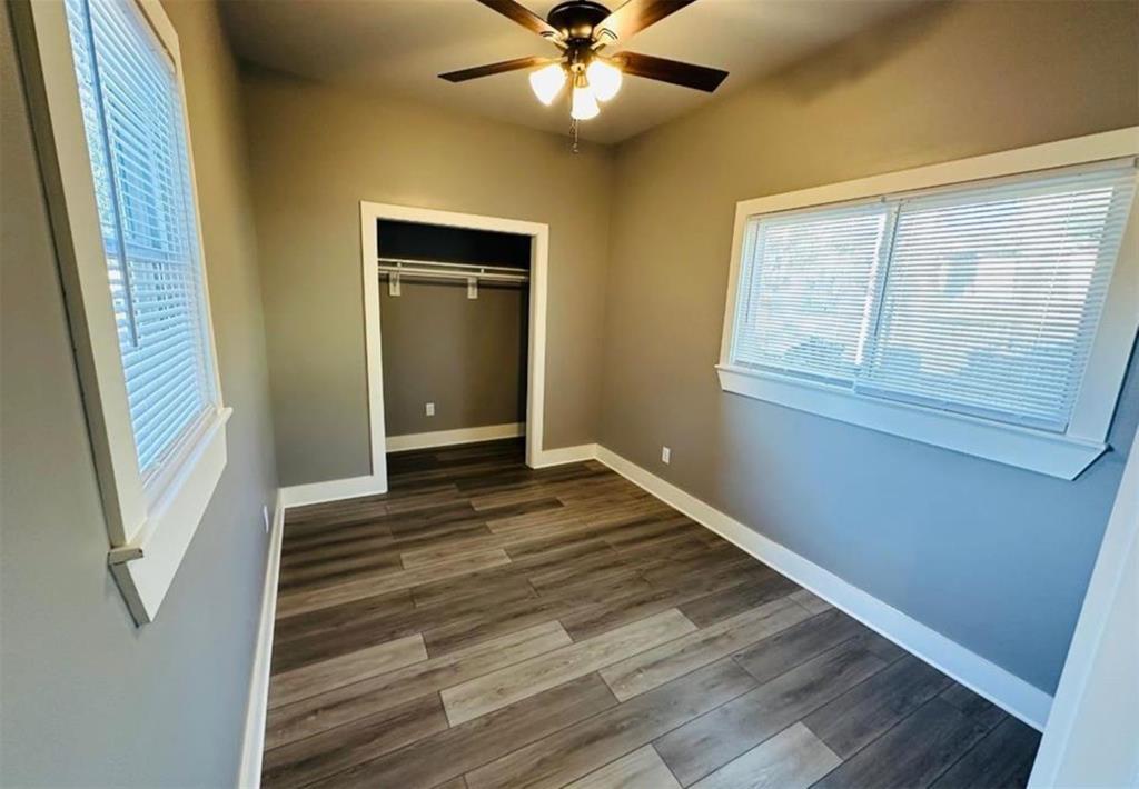 1408 East Houston Street Tyler, TX 75702 - Photo 11 of 15 a view of an empty room with wooden floor and a window