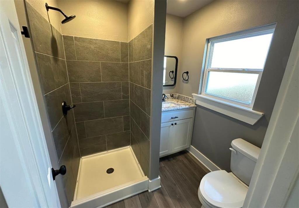 1408 East Houston Street Tyler, TX 75702 - Photo 8 of 15 a bathroom with a sink toilet and shower