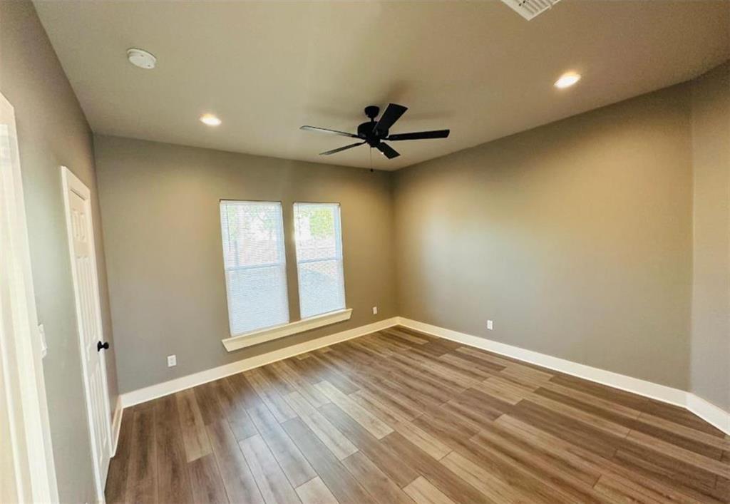 1408 East Houston Street Tyler, TX 75702 - Photo 9 of 15 wooden floor in an empty room with a window